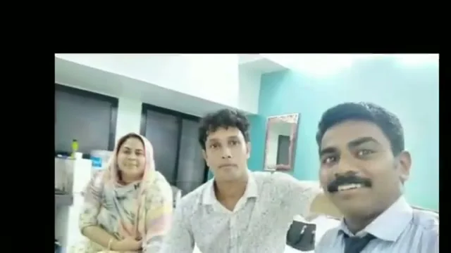 Satish with a couple in the Sevagan office